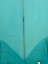 Load image into Gallery viewer, Close-up of a vintage turquoise surfboard with a center line