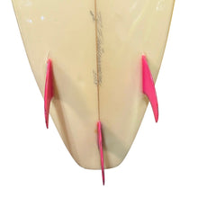 Load image into Gallery viewer, A close-up of the tail section of a surfboard showing a cream-colored underside with three bright pink fins, photographed on a white background.