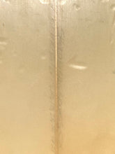 Load image into Gallery viewer, A close-up of a translucent, warm beige or champagne-colored material with a vertical wood seam running down the center.