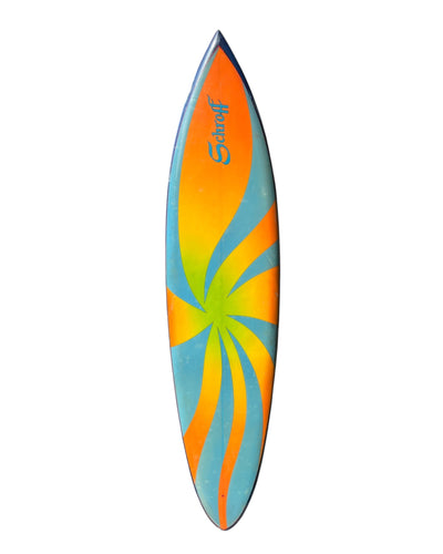 Colorful Schroff surfboard with a spiral design on a white background