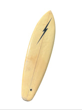 Load image into Gallery viewer, A vintage surfboard with a light natural wood finish, featuring a black lightning bolt graphic near the nose and a small dark hole near the tail, isolated on a white background.