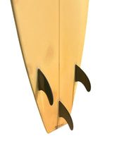 Load image into Gallery viewer, Close-up of a vintage surfboard with black fins on a white background