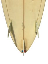 Load image into Gallery viewer, Close-up of a used surfboard with a visible brand logo on a white background