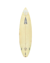 Load image into Gallery viewer, A Roberts surfboard with a natural light tan wood grain finish, featuring a black graphic logo near the center and pre-drilled holes at the tail, shown against a plain white background.