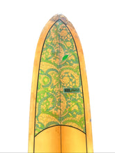 Load image into Gallery viewer, A vintage surfboard with a pointed nose, featuring a yellow and green floral pattern on the deck, photographed against a solid white background.