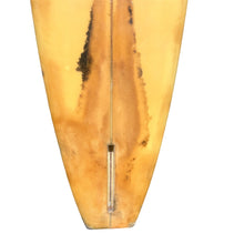 Load image into Gallery viewer, Close-up of the center of a surfboard tail showing a natural honey-amber wood grain with dark brown streaks and a metal fin attachment, isolated on a white background.
