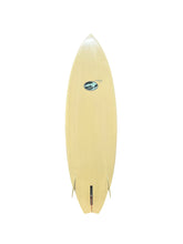 Load image into Gallery viewer, A light natural wood surfboard with a small blue and white logo near the center, shown from a top-down view on a solid white background.