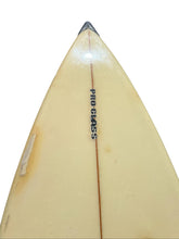 Load image into Gallery viewer, Close-up of the pointed nose of a vintage surfboard, showing a cream-colored fiberglass surface with a central wood grain line and the vertical text 'PRO GLASS' printed in black.