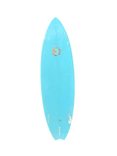 Load image into Gallery viewer, A light blue surfboard with a small circular logo near the top center, shown vertically against a plain white background.