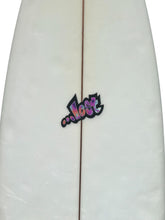 Load image into Gallery viewer, Close-up of a white surfboard with a central stringer line and a colorful '.
