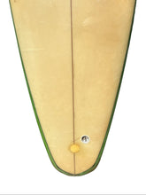Load image into Gallery viewer, Close-up of the tail section of a surfboard showing the natural light cream color, green edge trim.