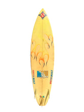 Load image into Gallery viewer, A vintage-style surfboard with a pale yellow body, orange and black flame graphics, and colorful 'SMITH BUILT' branding near the tail, shown against a plain white background.