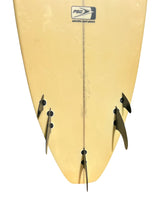 Load image into Gallery viewer, Close-up of the tail section of a pale yellow surfboard with three black fins attached and a visible PSO logo near the top.