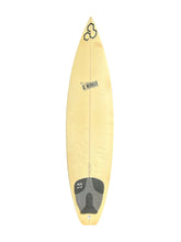 Load image into Gallery viewer, A light yellow surfboard with a black logo at the nose and a dark gray foot pad near the tail, shown against a plain white background.