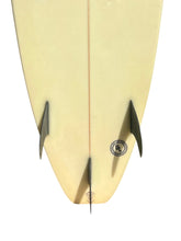 Load image into Gallery viewer, Close-up rear view of a surfboard tail with three dark fins and a circular Ulster surfboards logo, shown on a white background.