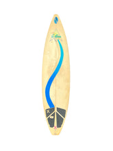 Load image into Gallery viewer, A long, narrow surfboard shown vertically against a plain white background. The board has a pale natural tone, a bold blue curved graphic running down the center, black grip pads near the tail, and a small multicolor logo near the nose.