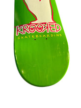 Load image into Gallery viewer, Close-up of a bright green skateboard deck with a cream graphic outline and the word 'KROOKED' in red outlined lettering, with 'SKATEBOARDING' in yellow below, on a white background.