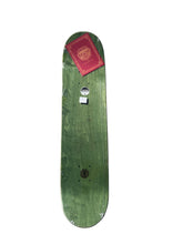 Load image into Gallery viewer, A green wooden skateboard deck with a red sticker on the nose, photographed vertically against a plain white background.