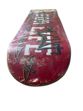 Load image into Gallery viewer, A vintage red skateboard deck with graffiti-style black and white markings, shown flat against a plain white background.