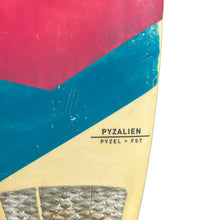 Load image into Gallery viewer, Close-up of a surfboard tail showing a geometric color-blocked design with a red top section, teal blue middle section, and cream lower section with a textured grip pad. The text 'PYZALIEN' and 'PYZEL + FST' are printed on the board.