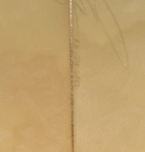 Load image into Gallery viewer, A close-up of a beige textured surface with a vertical line running down the center and faint etched markings near the middle.